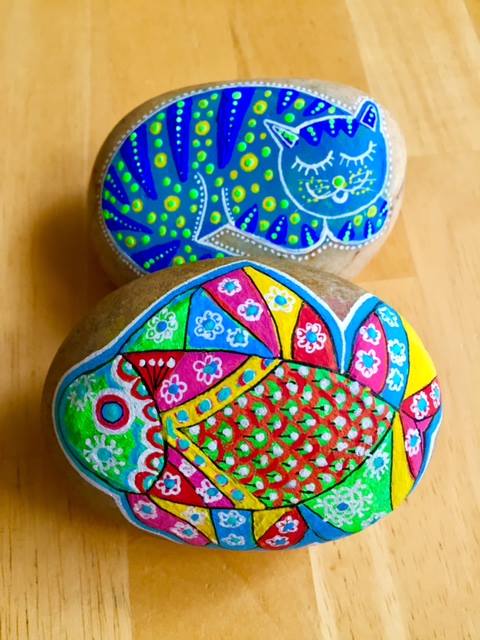 Gatos y peces pintados en piedras